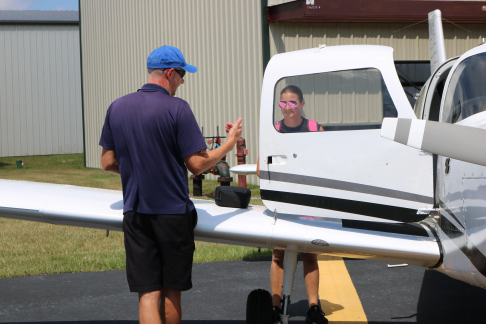 Instructor teaching student pilot preflight